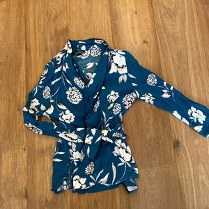 Green wrap around shirt with white flowers lightly worn